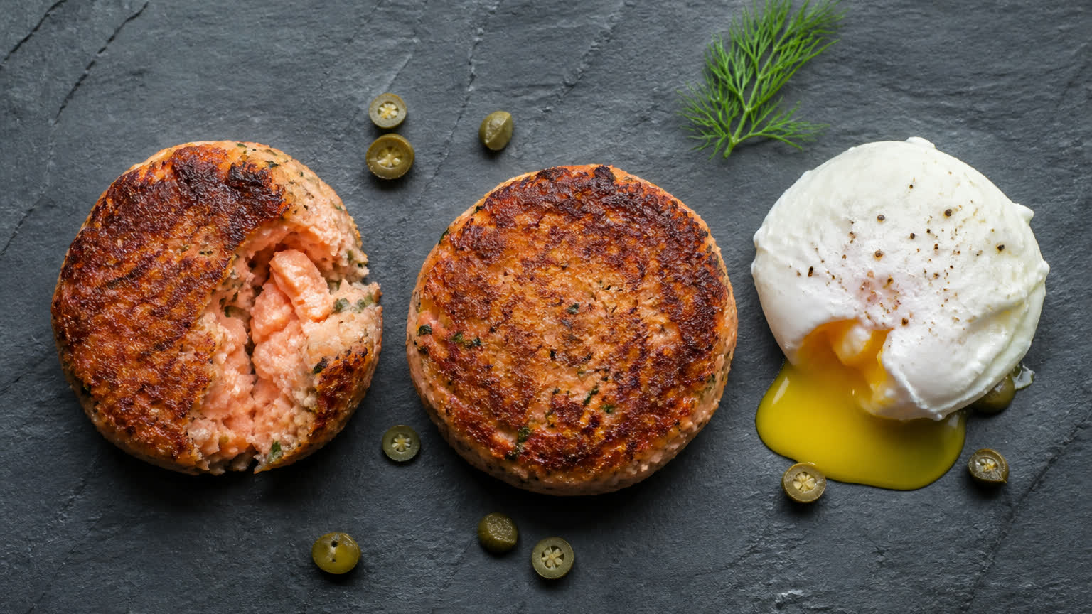 Salmon fishcakes with a soft poached egg on slate